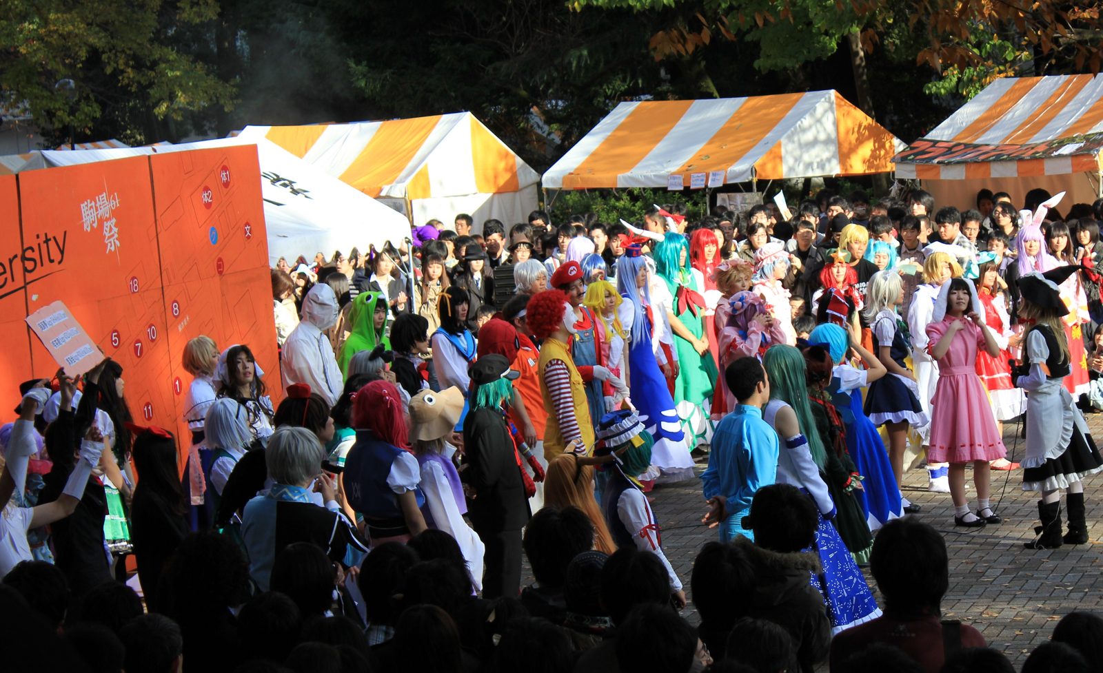 Crowds in costume between festival tents at Komabasai